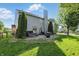 Grassy backyard includes a hot tub, patio, and manicured landscaping at 1454 Woodfield Dr, Greenwood, IN 46143