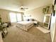 Bright bedroom with large windows, carpet floors, ceiling fan, and ample space at 1454 Woodfield Dr, Greenwood, IN 46143
