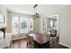 Bright dining room with large windows features a wooden table with seating and a modern chandelier at 1454 Woodfield Dr, Greenwood, IN 46143