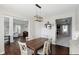 This dining room features a modern light fixture, seating for six, and hardwood floors at 1454 Woodfield Dr, Greenwood, IN 46143