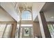 Grand foyer showcasing soaring ceilings, an arched window, and a stylish front door with decorative glass at 1454 Woodfield Dr, Greenwood, IN 46143