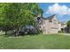Lovely two-story home with a well-maintained lawn, mature trees, and a welcoming green front door at 1454 Woodfield Dr, Greenwood, IN 46143