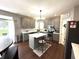 Modern kitchen with gray cabinets, an island with stool seating, stainless steel appliances, and a stylish backsplash at 1454 Woodfield Dr, Greenwood, IN 46143