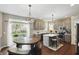 Well-lit kitchen featuring grey cabinets, quartz countertops, stainless steel appliances, and a breakfast nook at 1454 Woodfield Dr, Greenwood, IN 46143
