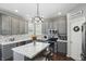 Updated kitchen showcasing gray cabinets, a center island with seating, and modern appliances at 1454 Woodfield Dr, Greenwood, IN 46143