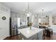 Eat-in kitchen featuring gray cabinets, stainless steel appliances, pantry, and modern lighting fixtures at 1454 Woodfield Dr, Greenwood, IN 46143