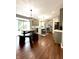 Bright kitchen with gray cabinets, an island, and a cozy dining area with a unique bench and table setup at 1454 Woodfield Dr, Greenwood, IN 46143