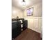 A well-lit laundry room is equipped with modern black washer and dryer units at 1454 Woodfield Dr, Greenwood, IN 46143