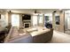 Open-concept living room with a fireplace, large sectional, and views into the adjacent modern kitchen and dining area at 1454 Woodfield Dr, Greenwood, IN 46143
