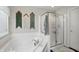 Bright bathroom featuring a soaking tub, a shower, and decorative tapestries at 1454 Woodfield Dr, Greenwood, IN 46143