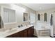 Relaxing bathroom with a double sink vanity, a large soaking tub, and a separate shower at 1454 Woodfield Dr, Greenwood, IN 46143