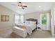 Bright main bedroom featuring neutral walls, a ceiling fan, a decorative bed, and large windows at 1454 Woodfield Dr, Greenwood, IN 46143