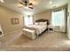 Spacious bedroom with a ceiling fan, natural light, and a seating area near the windows at 1454 Woodfield Dr, Greenwood, IN 46143