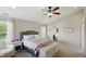 Bright and airy main bedroom with decorative walls, a ceiling fan, a comfortable bed, and a window at 1454 Woodfield Dr, Greenwood, IN 46143