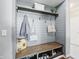 Charming mudroom features custom shelving, bench with storage, and stylish gray shiplap walls at 1454 Woodfield Dr, Greenwood, IN 46143