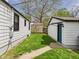 View of fenced-in backyard with lush green lawn and detached garage at 1505 E 30Th St, Anderson, IN 46016