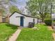 Back exterior view of home, showing green grass, landscaping, and the backyard at 1505 E 30Th St, Anderson, IN 46016