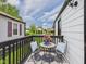 Outdoor balcony with black metal table and chairs, with neighborhood street view at 1505 E 30Th St, Anderson, IN 46016