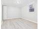 Clean basement with light vinyl floors, window, and access door at 1505 E 30Th St, Anderson, IN 46016