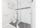 Modern bathroom with black and white tiled shower and mosaic tile floor at 1505 E 30Th St, Anderson, IN 46016