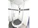 Stylish bathroom shower featuring black accent tiles and a mosaic tile floor at 1505 E 30Th St, Anderson, IN 46016