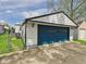 Detached garage with a large blue door and concrete driveway at 1505 E 30Th St, Anderson, IN 46016
