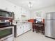 Functional kitchen with white cabinets, stainless steel appliances, and an adjacent eating area at 1505 E 30Th St, Anderson, IN 46016