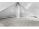 Large attic featuring high ceilings, exposed brick, and plush carpet at 1505 Spann Ave, Indianapolis, IN 46203