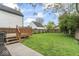 Large backyard lawn with wooden deck and fence at 1505 Spann Ave, Indianapolis, IN 46203