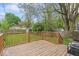 Spacious wooden backyard deck overlooking lawn and wooden fence at 1505 Spann Ave, Indianapolis, IN 46203
