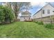Large backyard with green grass, deck, and wooden fence at 1505 Spann Ave, Indianapolis, IN 46203
