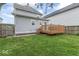 A wooden deck sits nestled in the green backyard of a charming home with light blue siding at 1505 Spann Ave, Indianapolis, IN 46203