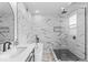 Bathroom with white marble-style tile and modern glass shower and free standing tub at 1505 Spann Ave, Indianapolis, IN 46203