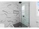 Modern bathroom featuring sleek glass shower, black hardware, and unique wall tile at 1505 Spann Ave, Indianapolis, IN 46203