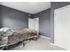 Cozy bedroom features grey walls, carpeted floor, and door to the hallway at 1505 Spann Ave, Indianapolis, IN 46203