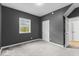 Charming bedroom featuring neutral carpet, soft lighting, and bright window at 1505 Spann Ave, Indianapolis, IN 46203