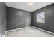 Spacious bedroom with neutral carpet, soft lighting, and bright window at 1505 Spann Ave, Indianapolis, IN 46203