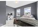 Comfortable bedroom with two windows, gray walls and carpet at 1505 Spann Ave, Indianapolis, IN 46203