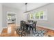 Elegant dining room with wood floors, modern lighting, and a view into the kitchen at 1505 Spann Ave, Indianapolis, IN 46203