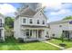 Charming two-story home with covered front porch and well-manicured lawn at 1505 Spann Ave, Indianapolis, IN 46203