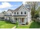 Beautiful two-story home with a quaint covered porch and lush green lawn at 1505 Spann Ave, Indianapolis, IN 46203