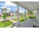 Covered front porch with seating area offers a relaxing view of the tree-lined street at 1505 Spann Ave, Indianapolis, IN 46203