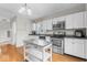 Well-lit kitchen features stainless steel appliances, white cabinets, and a moveable island at 1505 Spann Ave, Indianapolis, IN 46203
