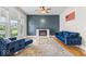 Cozy living room featuring a fireplace, blue furniture, and large windows at 1505 Spann Ave, Indianapolis, IN 46203