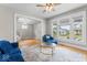 Bright living room with large windows, hardwood floors, and comfortable blue seating at 1505 Spann Ave, Indianapolis, IN 46203