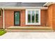 The backyard features a brick exterior and wood porch outside large glass windows at 1510 Continental Dr, Zionsville, IN 46077