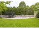 A trampoline and climbing structure are in the backyard with a white fence and trees at 1510 Continental Dr, Zionsville, IN 46077