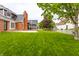 The backyard features a lawn with a screened in porch off of the brick house at 1510 Continental Dr, Zionsville, IN 46077