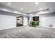 Spacious finished basement with recessed lights, neutral carpet and convenient wet bar at 1510 Continental Dr, Zionsville, IN 46077