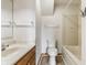 Cozy bathroom with a wood vanity, a white sink, a commode, and a tub-shower combination at 1510 Continental Dr, Zionsville, IN 46077